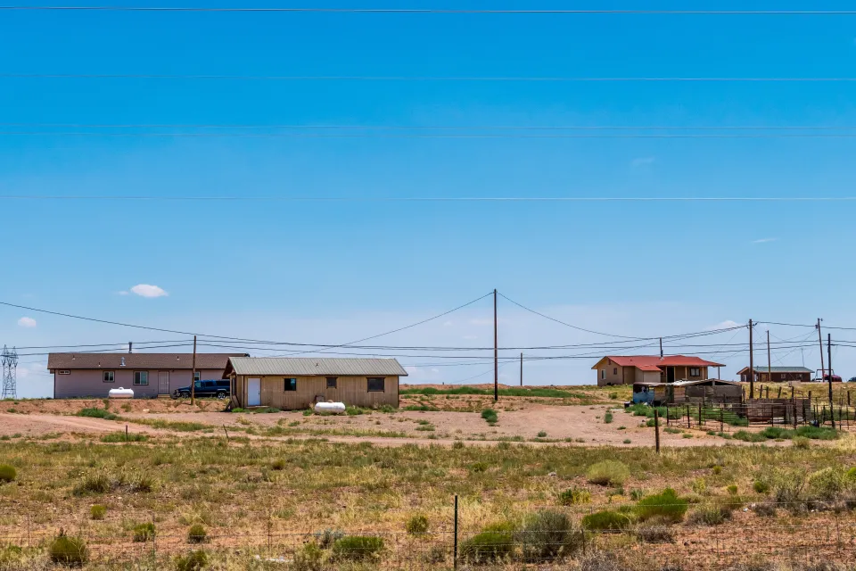 View of three manufactured homes on a hill somewhere in Navajo Nation
